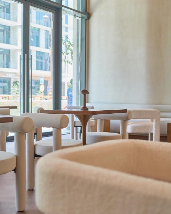 Warm sunlit seating and soft cream furnishings inside Define café