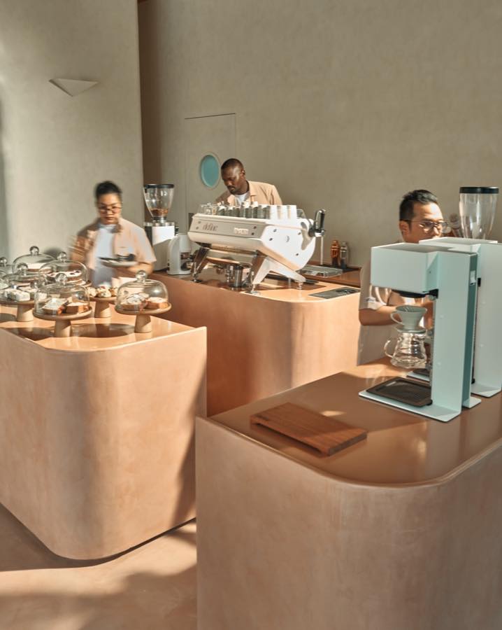 Define’s baristas preparing coffee at the sculptural terracotta counter